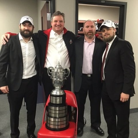 Coaching staff with the trophy